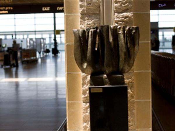 A bronze sculpture of a Menorah, by Chaim Ragine